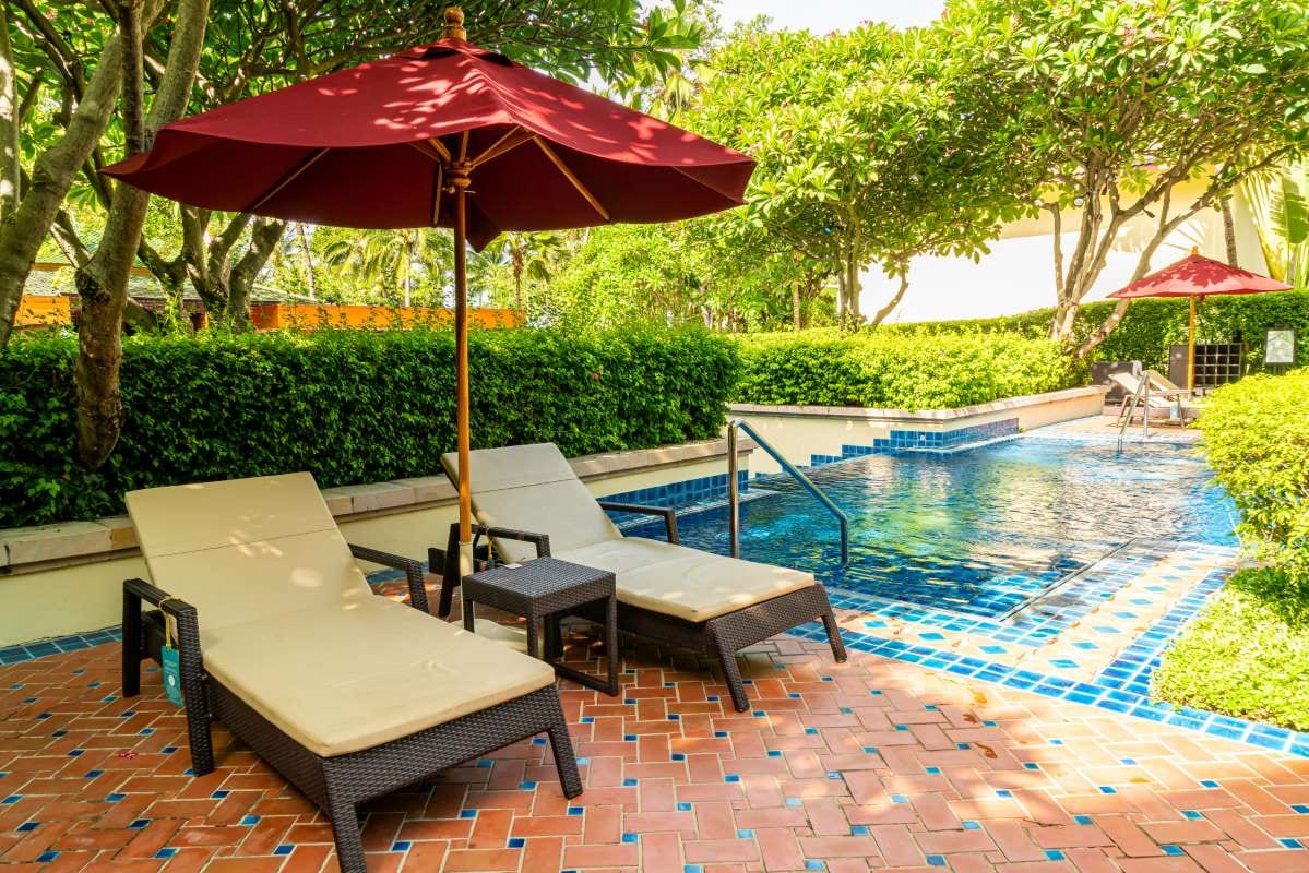 Hotel resort poolside lounge beds beside a swimming pool