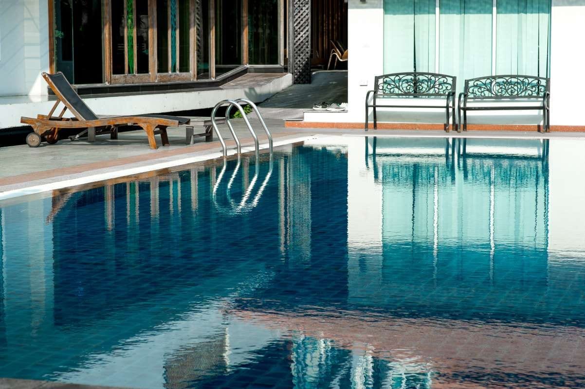Blue swimming pool with ample copy space and a relaxed summer vibe