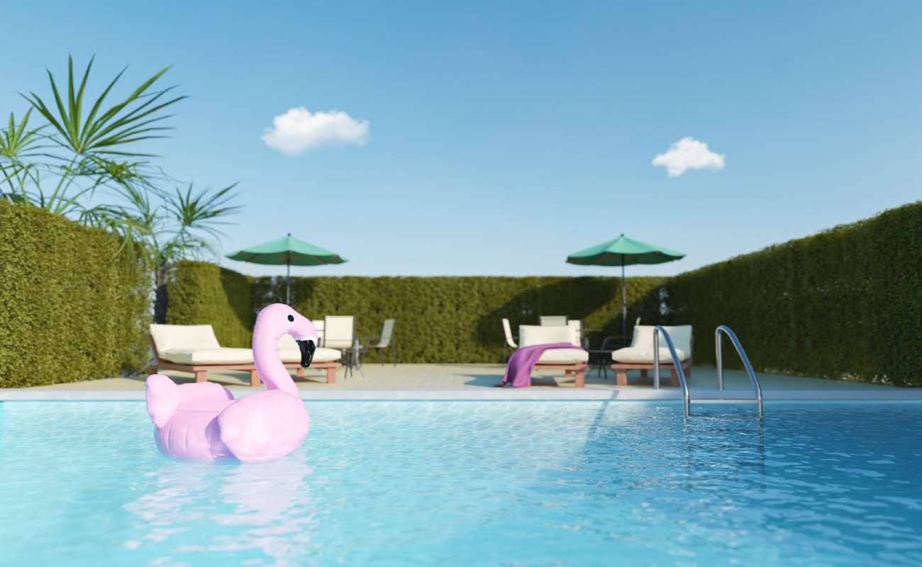 Flamingo float beside a terrace overlooking a swimming pool