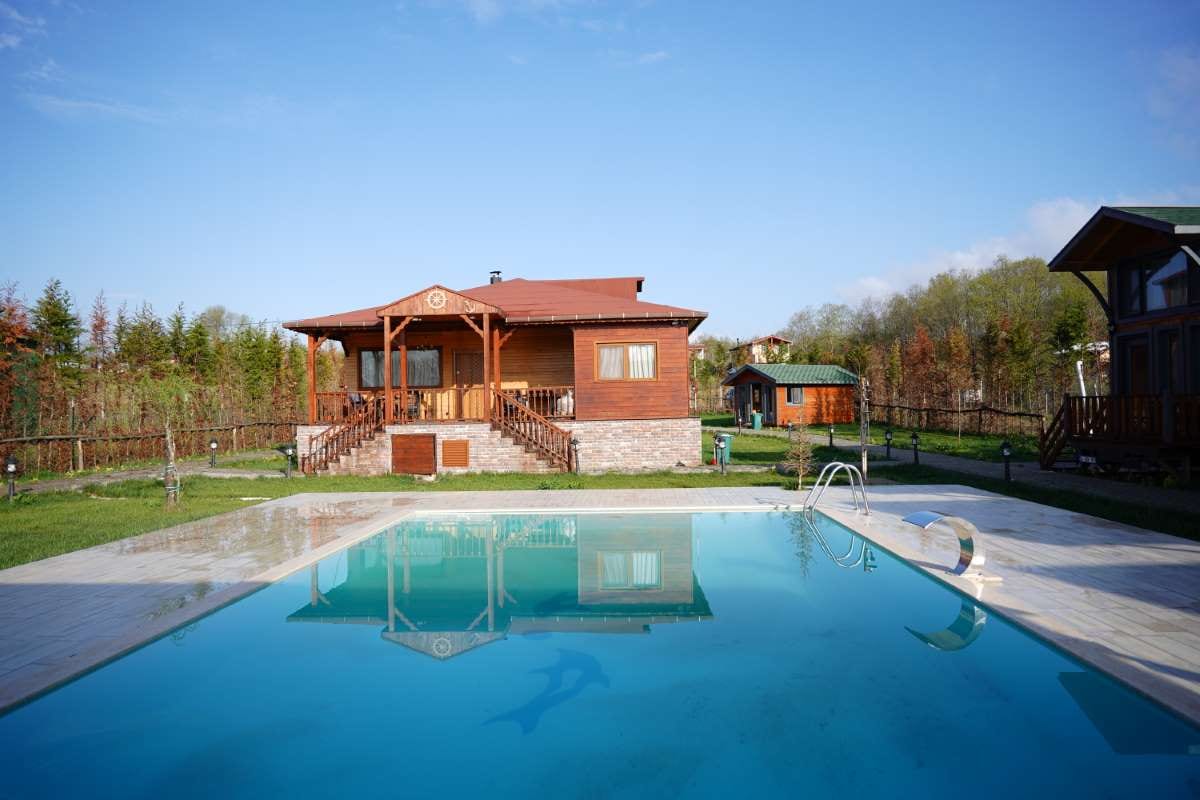 House with a backyard pool in the background