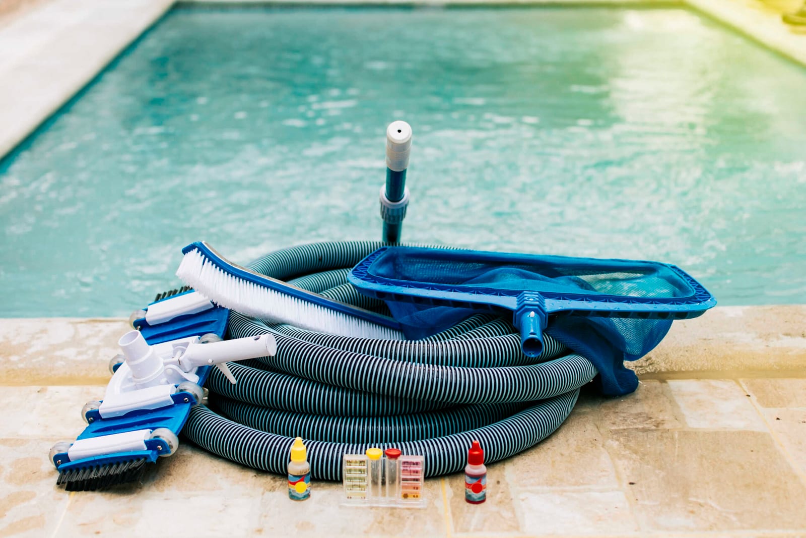 Pool cleaning maintenance kit with vacuum, pH tester, leaf picker, and sweeper