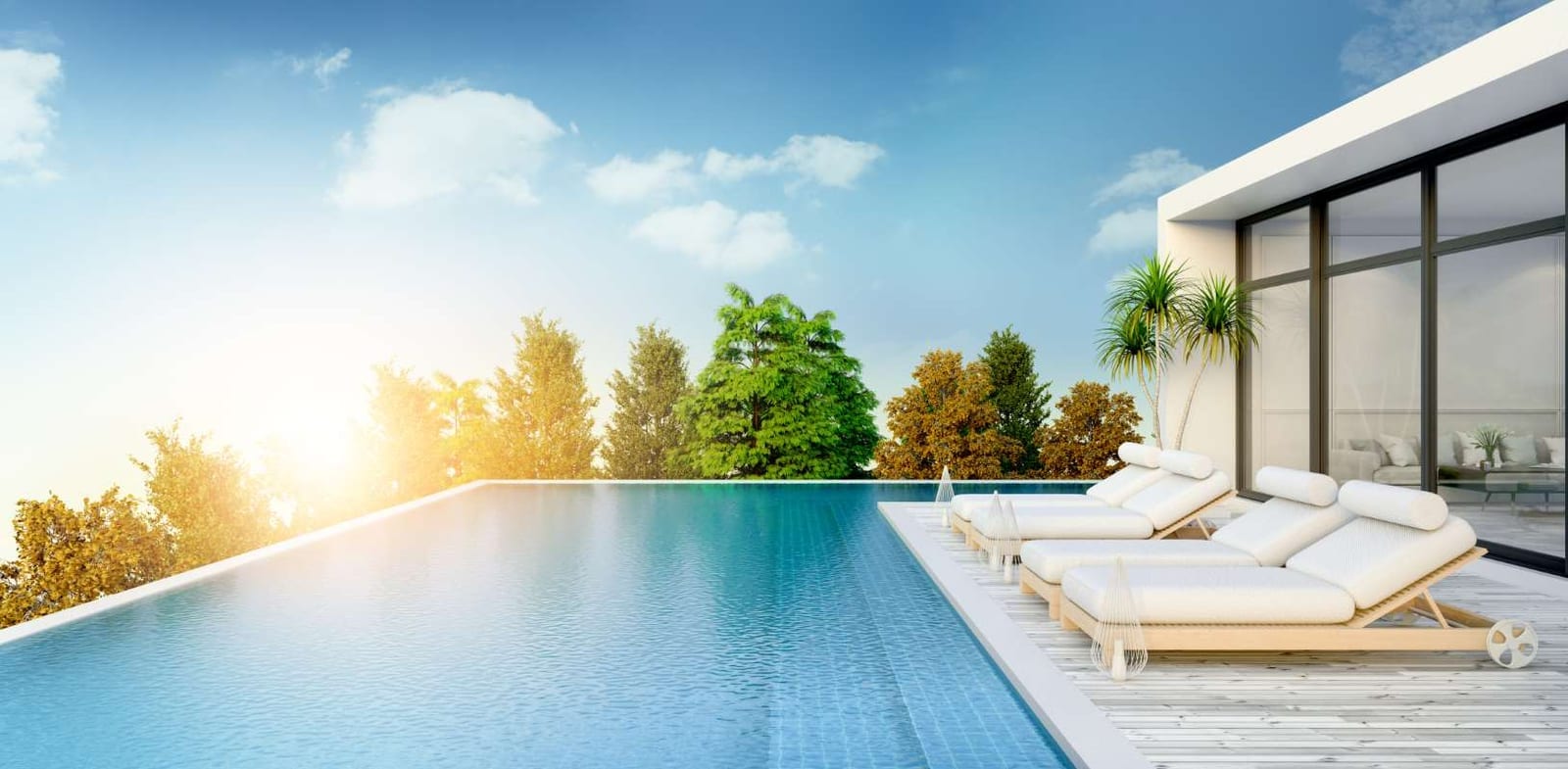 Summer beach lounge with sun loungers beside a private swimming pool