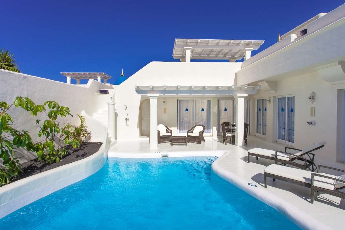 Luxury poolside sun loungers beside a jacuzzi