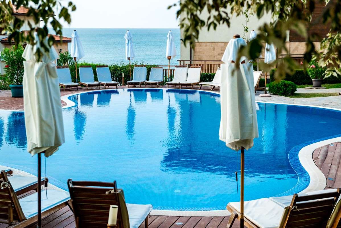 Swimming pool by the sea in the morning light