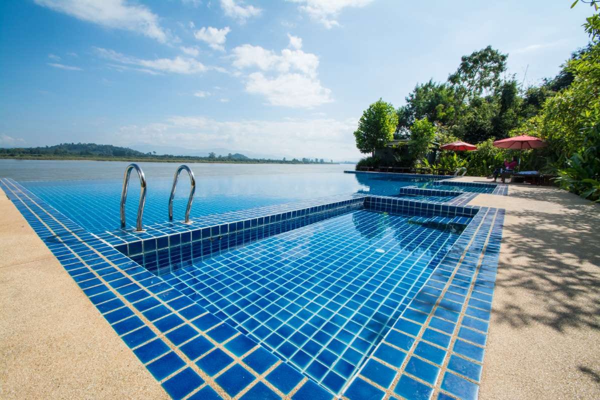 Swimming pool near the Khong River under a blue Chiang Rai sky in Thailand