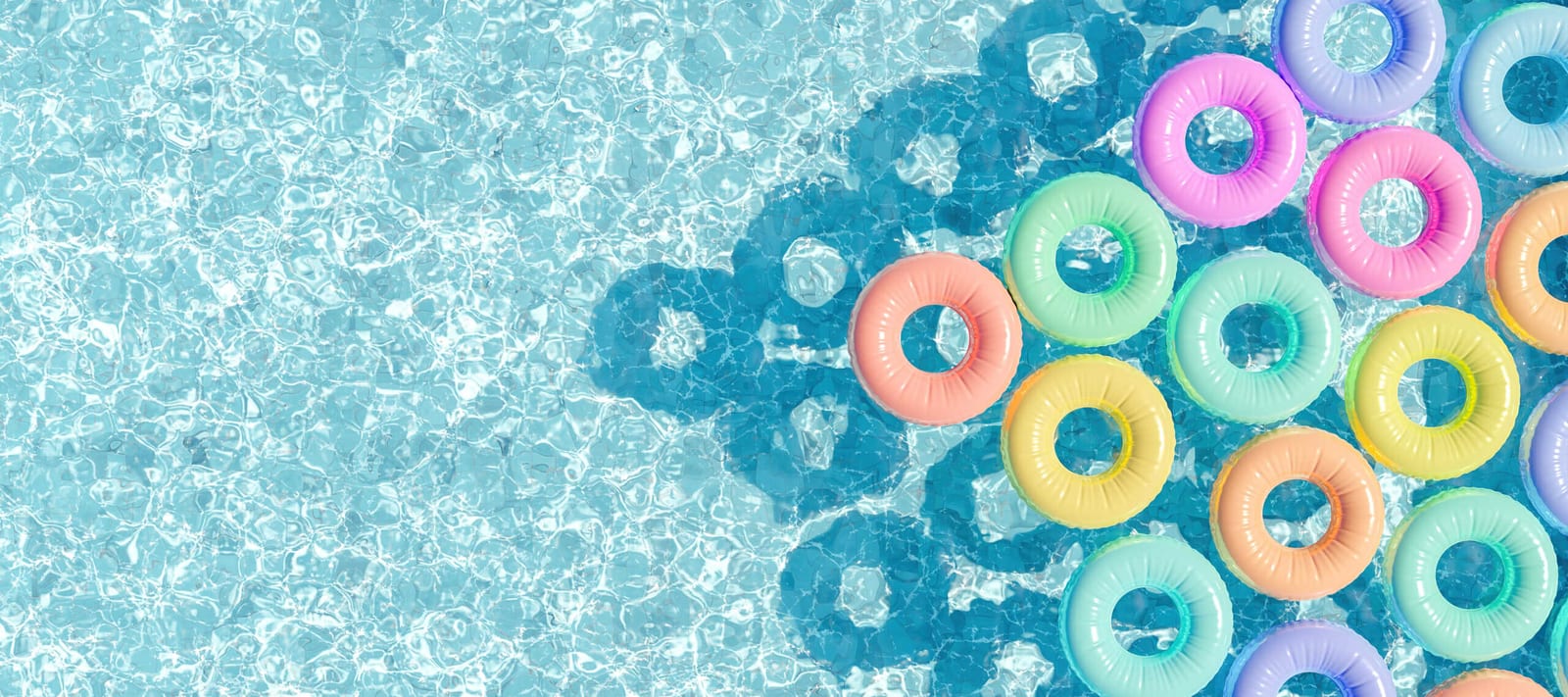 Pastel pool rings floating on the surface of a swimming pool