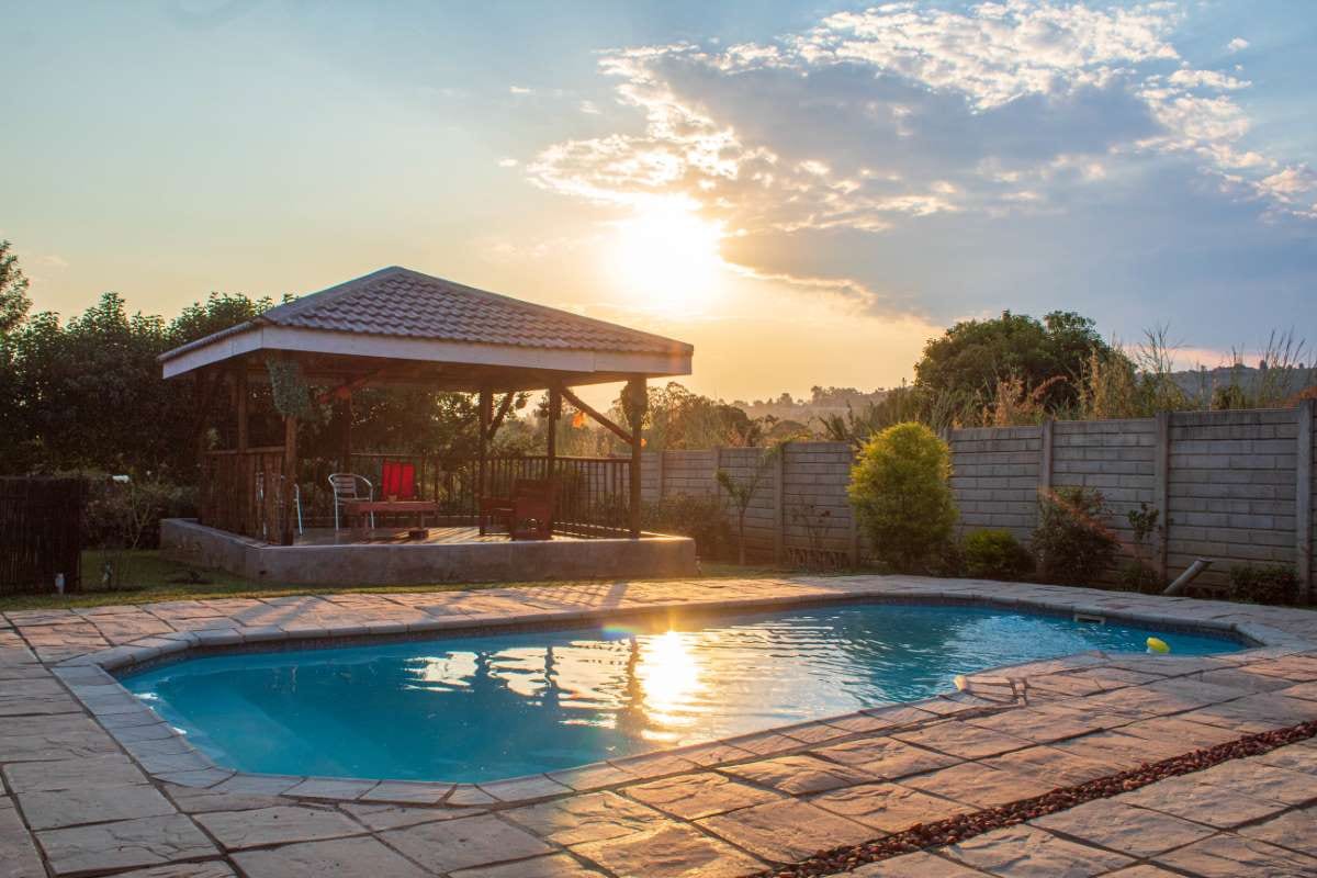 Swimming pool at sunset with calm water and evening reflections